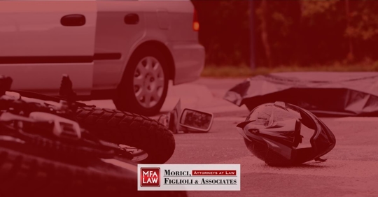 motorcycle lying in the road after being hit by car
