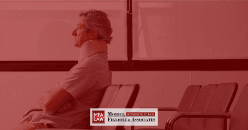 man with neck brace sitting in a waiting room