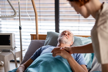 female doctor examining senior patient