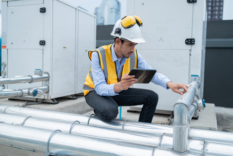 man inspects industrial park roof
