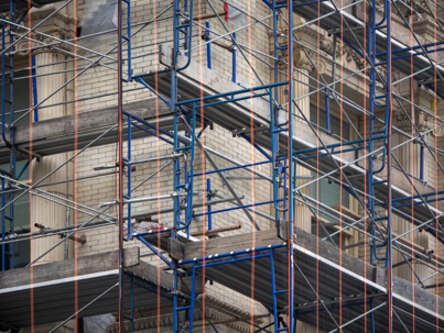 blue scaffolding with wooden planks