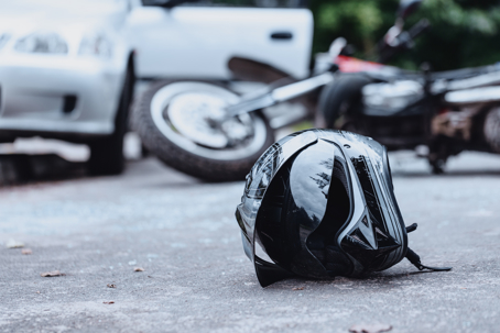 biker helmet on the street with overturned motorbike