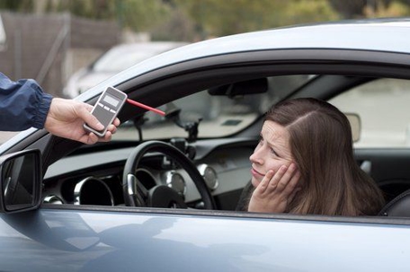 woman taking breathalizer test